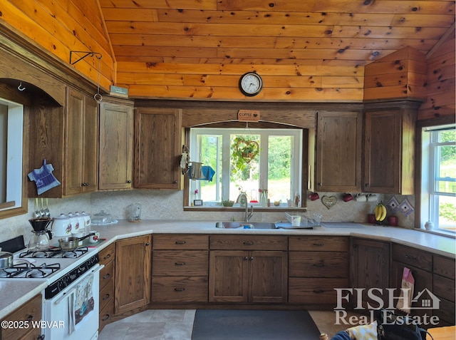 3178 W Winter Rd, Loganton, PA 17747 - kitchen with white gas range, lofted ceiling, decorative backsplash, light countertops, and wooden ceiling