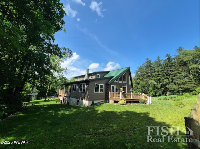 3178 W Winter Rd, Loganton, PA 17747 - rear view of property with a wooden deck, a yard, a metal roof, and an outbuilding