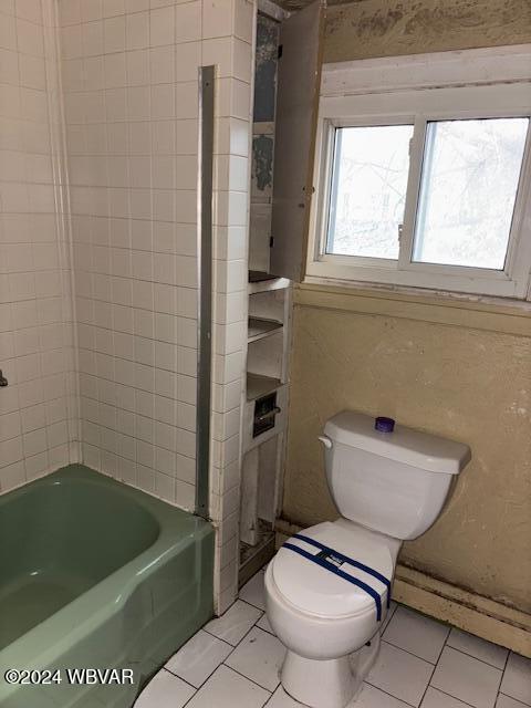 bathroom featuring tile patterned floors, toilet, shower / bathtub combination, and a baseboard heating unit