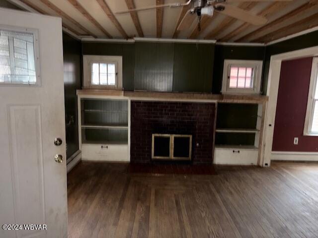 unfurnished living room featuring ceiling fan and hardwood / wood-style flooring