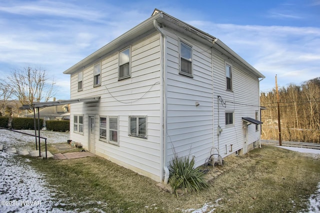 view of snow covered exterior featuring a yard