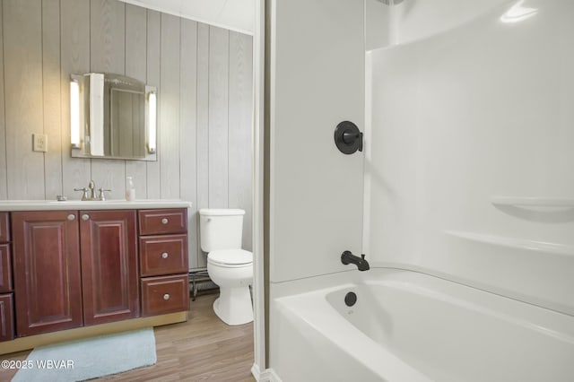 full bathroom with vanity, shower / washtub combination, toilet, and wood walls