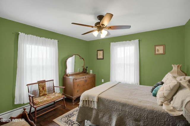 bedroom with ceiling fan and dark hardwood / wood-style flooring