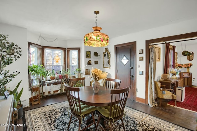 dining room with wood-type flooring and a baseboard heating unit