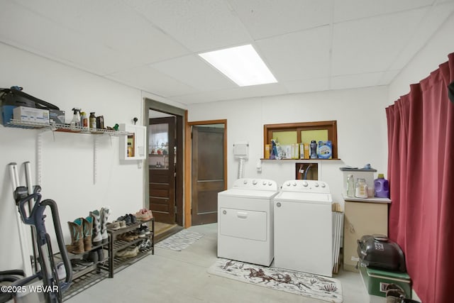 clothes washing area with washer and clothes dryer