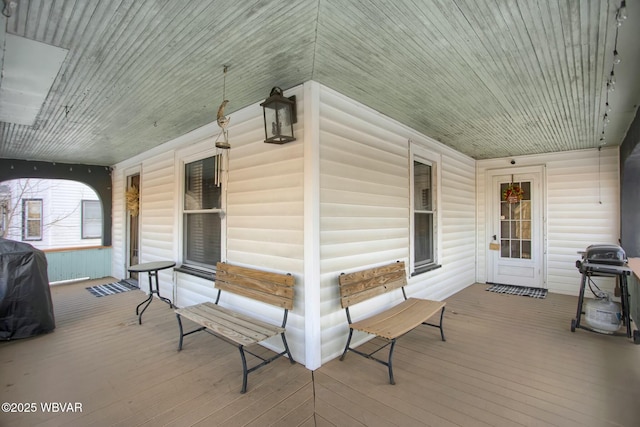 wooden deck with a porch and grilling area