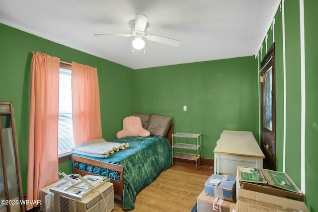 bedroom with light hardwood / wood-style flooring and ceiling fan