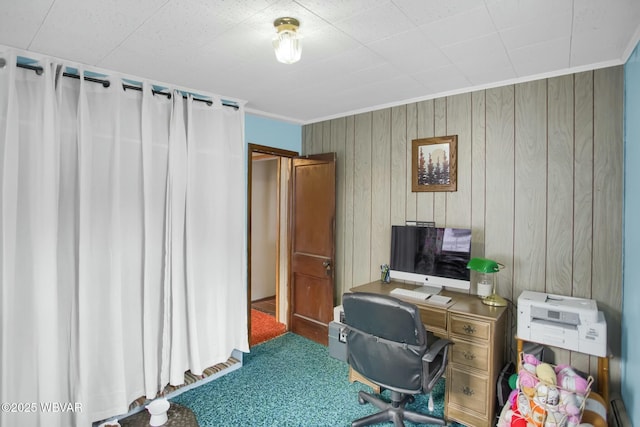 office space with crown molding, carpet, and wood walls