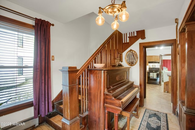 miscellaneous room with a baseboard radiator, plenty of natural light, and an inviting chandelier