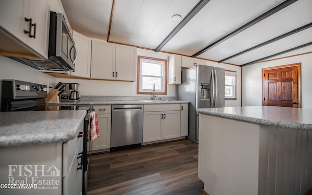 kitchen featuring white cabinetry, appliances with stainless steel finishes, sink, and lofted ceiling