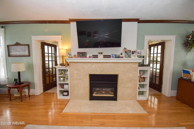 45 W Bald Eagle St, Lock Haven, PA 17745 - living room featuring crown molding, wood finished floors, healthy amount of natural light, baseboards, and a tile fireplace
