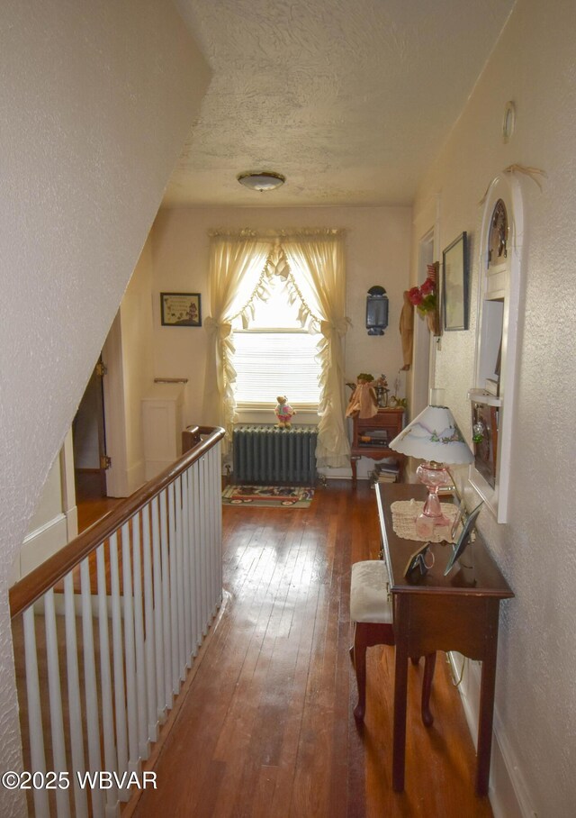45 W Bald Eagle St, Lock Haven, PA 17745 - hall featuring radiator, wood-type flooring, a textured ceiling, and a textured wall