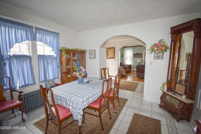 45 W Bald Eagle St, Lock Haven, PA 17745 - dining area with arched walkways, light tile patterned flooring, a textured ceiling, and radiator