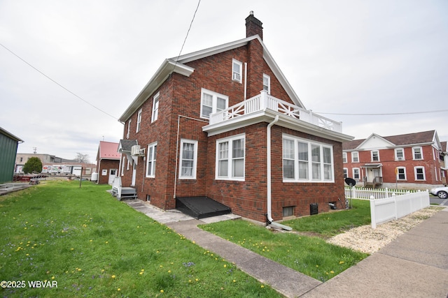 45 W Bald Eagle St, Lock Haven, PA 17745 - view of property exterior featuring a balcony, brick siding, and a chimney