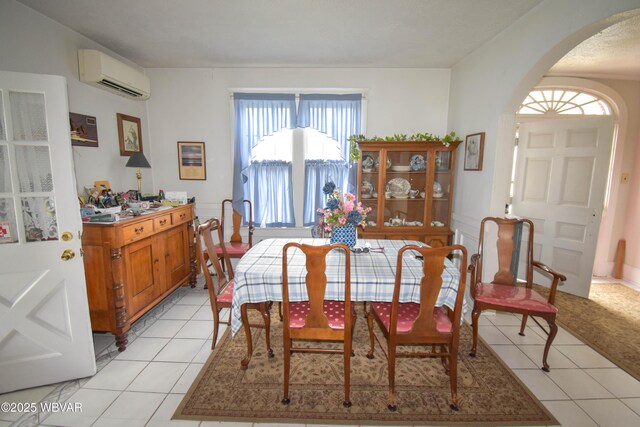 45 W Bald Eagle St, Lock Haven, PA 17745 - dining space with a wall mounted AC, arched walkways, and light tile patterned flooring