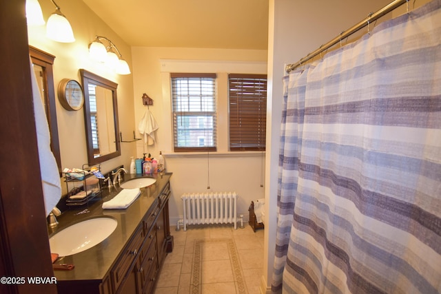45 W Bald Eagle St, Lock Haven, PA 17745 - full bathroom featuring radiator heating unit, tile patterned floors, inlaid floor details, double vanity, and baseboards