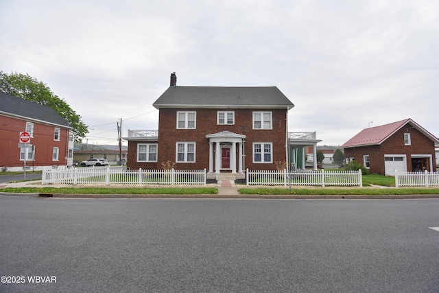 45 W Bald Eagle St, Lock Haven, PA 17745 - view of front facade with a chimney, a fenced front yard, and brick siding