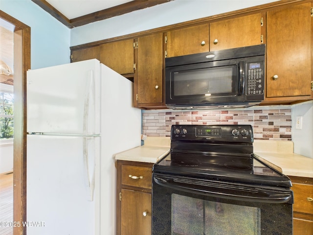 5667 Austinville Rd, Columbia Crossroads, PA 16914 - kitchen with black appliances, backsplash, and brown cabinets