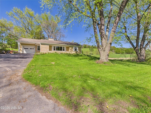 5667 Austinville Rd, Columbia Crossroads, PA 16914 - single story home featuring a garage, asphalt driveway, a front lawn, and a chimney