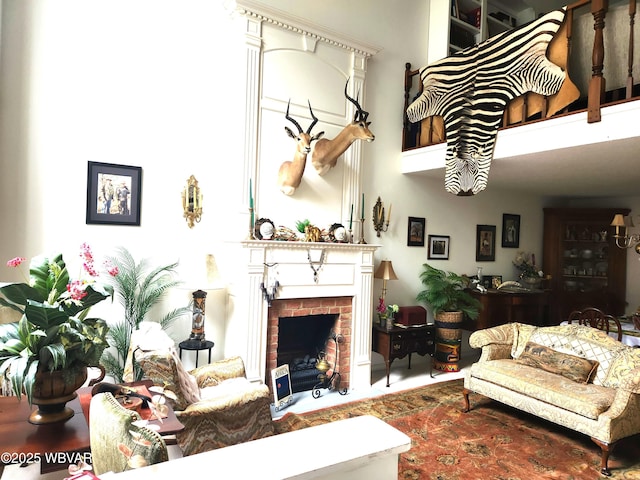living room with a high ceiling and a fireplace