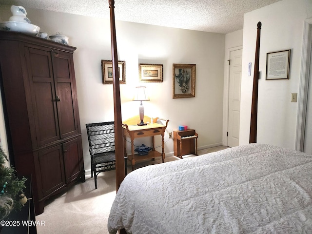 bedroom with light carpet, a textured ceiling, and baseboards