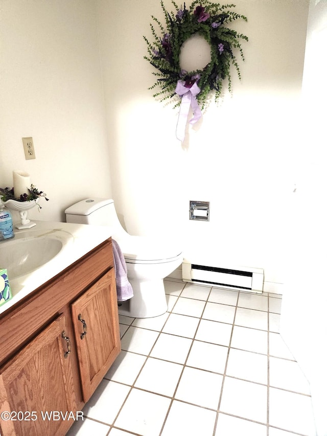bathroom with vanity, tile patterned flooring, baseboard heating, and toilet