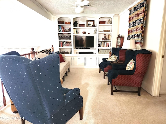 living area featuring carpet flooring, ceiling fan, and a textured ceiling