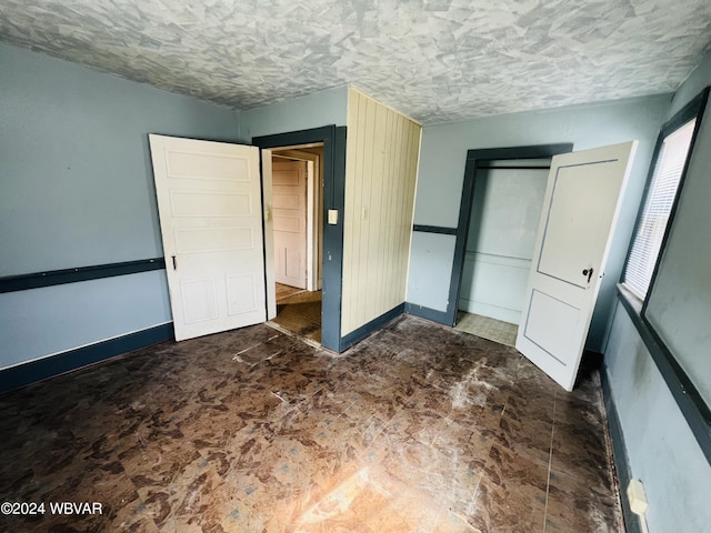 unfurnished bedroom with a closet and a textured ceiling