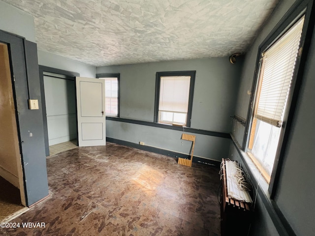 unfurnished bedroom with a textured ceiling