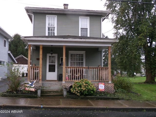 view of front property featuring covered porch