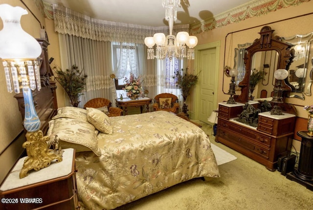 bedroom featuring a chandelier and carpet floors