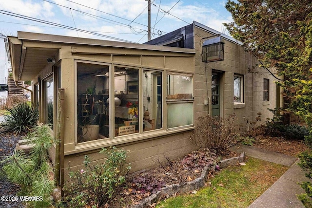 view of side of property with a sunroom