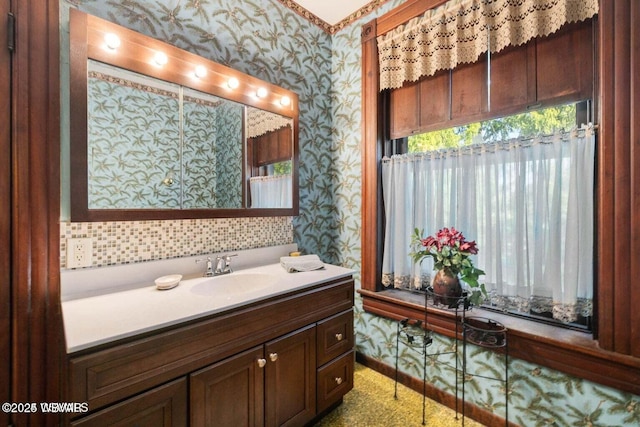 bathroom featuring vanity and tasteful backsplash