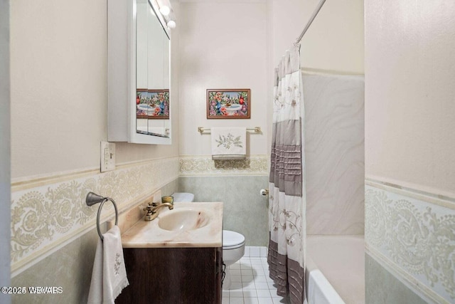 full bathroom with shower / bath combo, tile patterned flooring, toilet, vanity, and tile walls