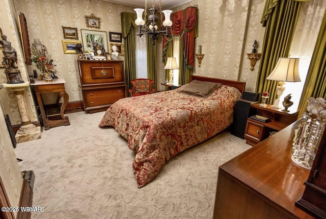 carpeted bedroom featuring an inviting chandelier