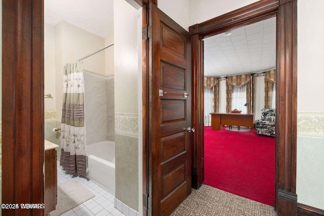 bathroom featuring tile patterned floors and shower / bathtub combination with curtain