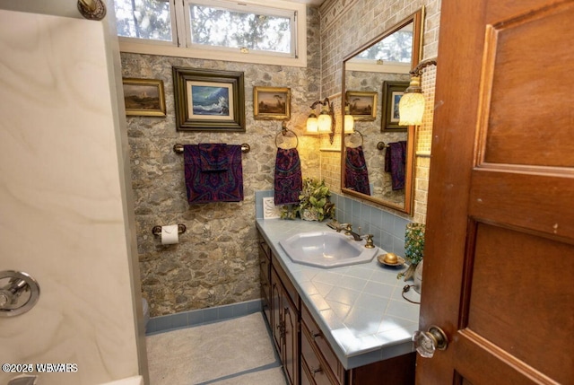 bathroom with tile patterned floors and vanity