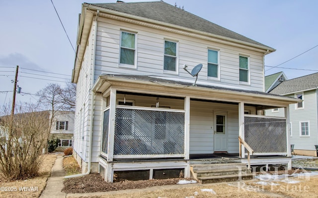 view of front of house featuring a shingled roof and a porch