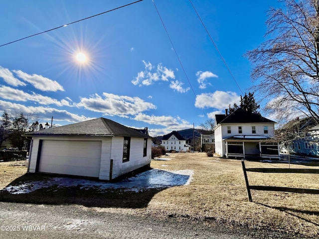 view of home's exterior with a garage and fence