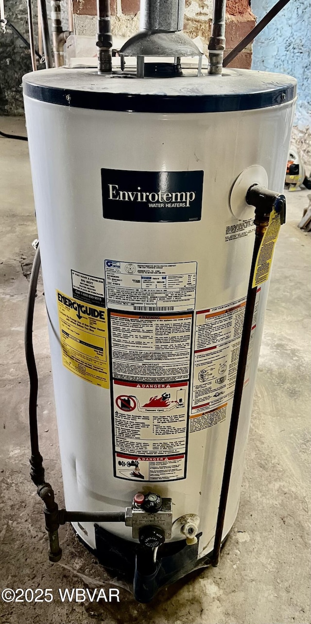 interior details featuring water heater and concrete floors