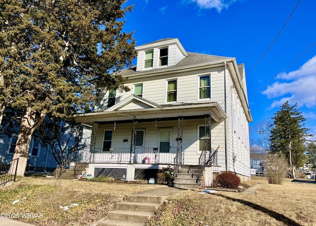 american foursquare style home with covered porch