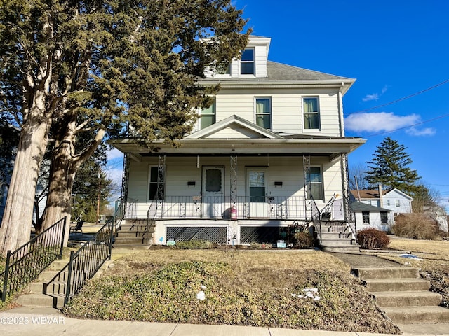 american foursquare style home featuring a porch