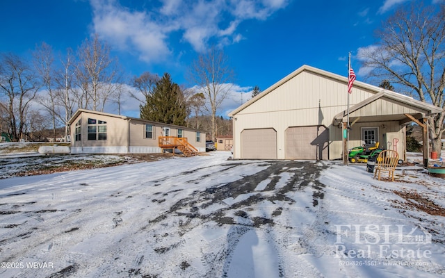 view of snow covered exterior with a garage