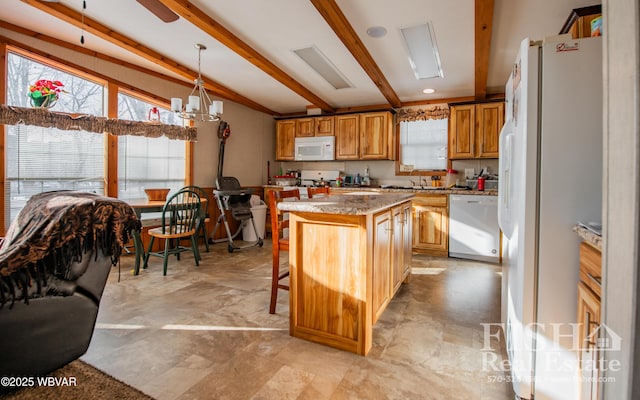 kitchen featuring a kitchen bar, decorative light fixtures, white appliances, a kitchen island, and lofted ceiling with beams