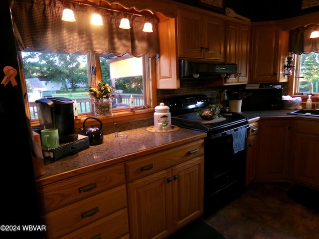 kitchen featuring ventilation hood, light stone counters, and black appliances