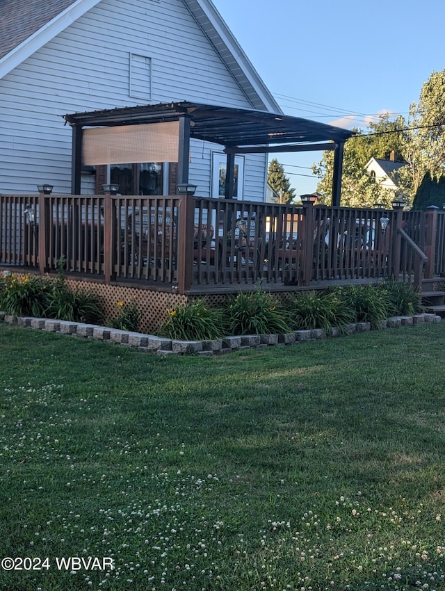 rear view of house with a lawn, a pergola, and a wooden deck