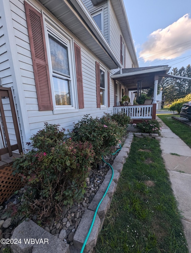 property exterior at dusk with covered porch