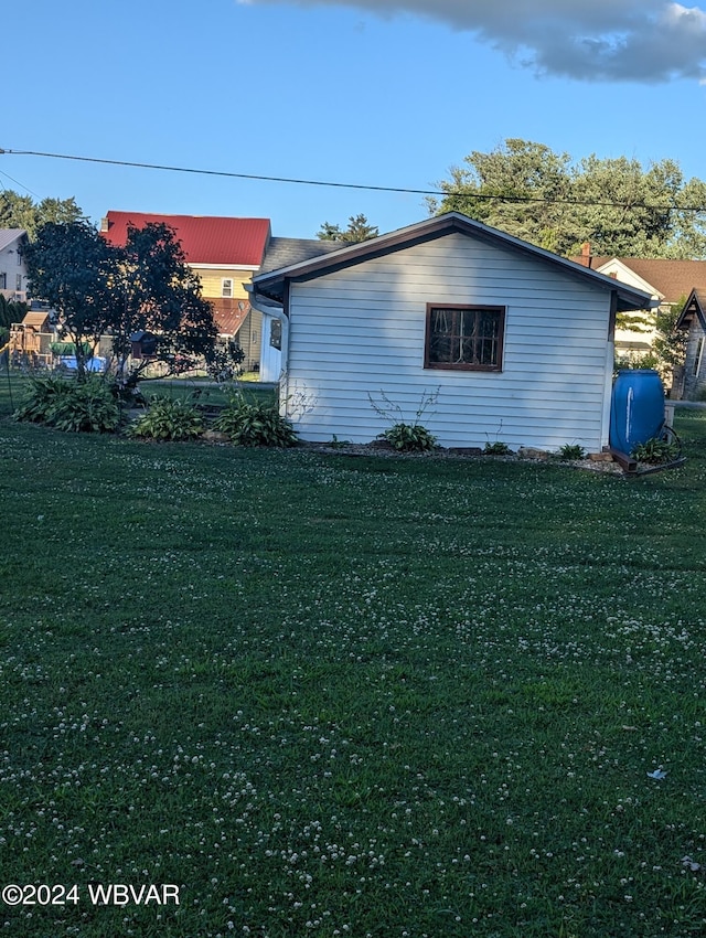 view of side of home featuring a lawn