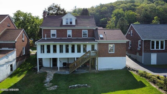 rear view of house with a lawn