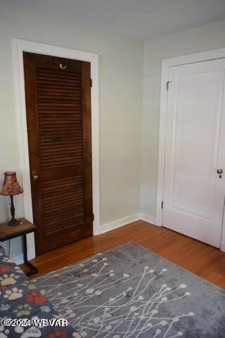 unfurnished bedroom with hardwood / wood-style floors and a closet